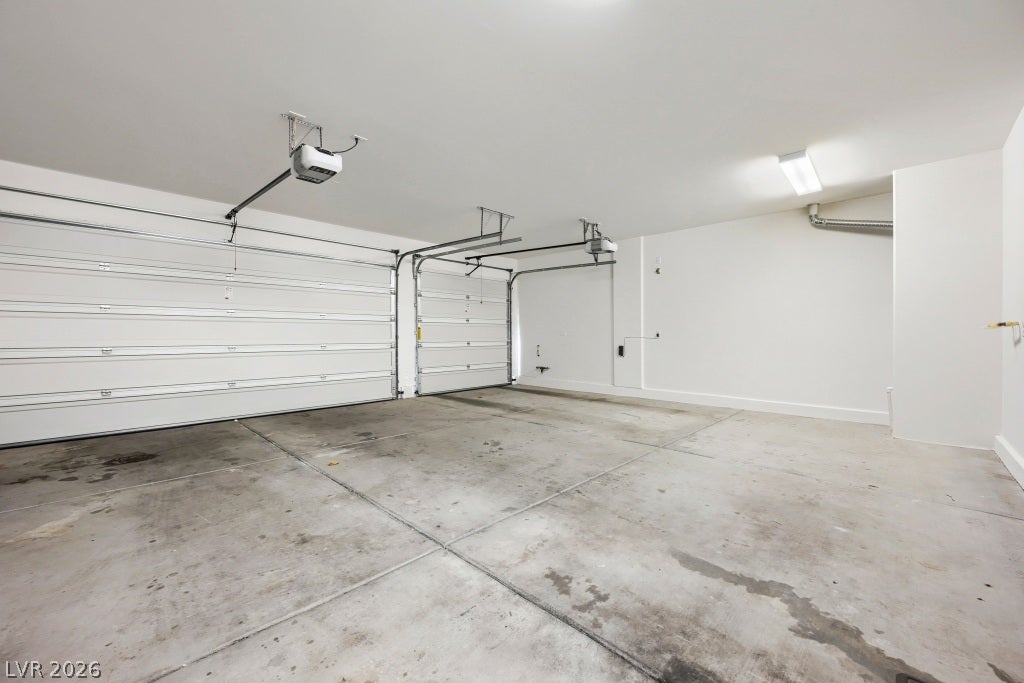 7241 Glistening Star Street, North Las Vegas, NV 89084 Concrete flooring and high ceilings define this expansive multi-car garage space.