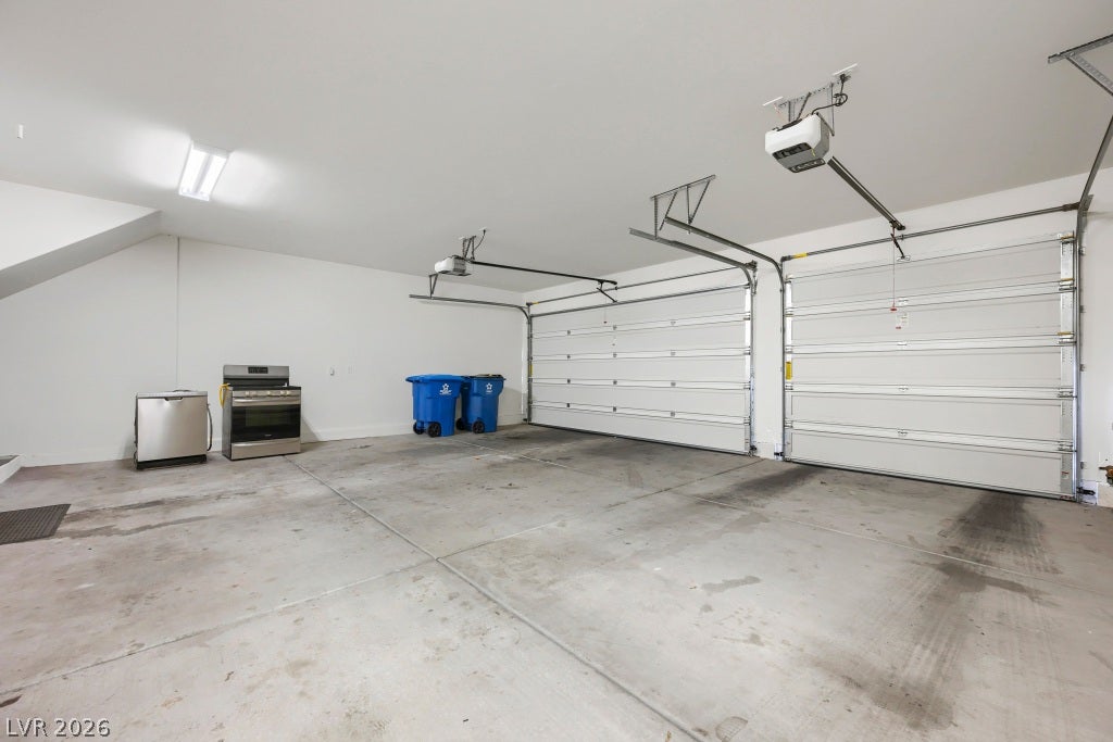 7241 Glistening Star Street, North Las Vegas, NV 89084 An accommodating three-car garage features durable concrete flooring and overhead automatic openers.