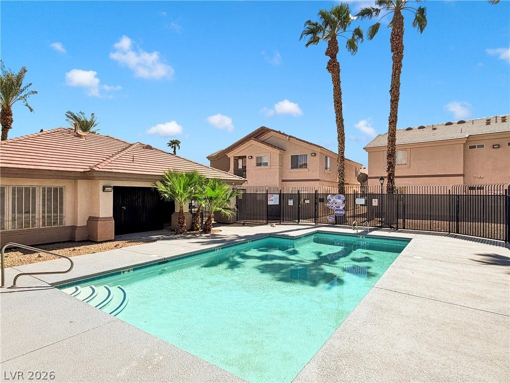 1520 Frank Aved Street, #201, Las Vegas, NV 89110 Palm trees sway over a sparkling pool surrounded by a spacious concrete deck.