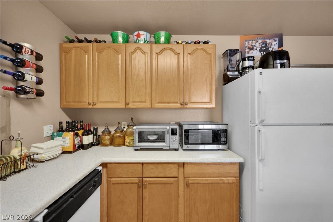 1520 Frank Aved Street, #201, Las Vegas, NV 89110 Ample wooden cabinetry and classic countertops provide extensive utility in this functional kitchen space.
