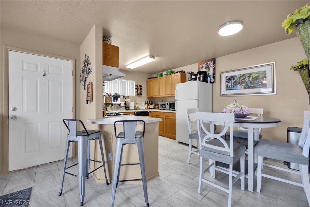 1520 Frank Aved Street, #201, Las Vegas, NV 89110 An open layout connects the entryway, breakfast bar, and cozy dining area with tile flooring.