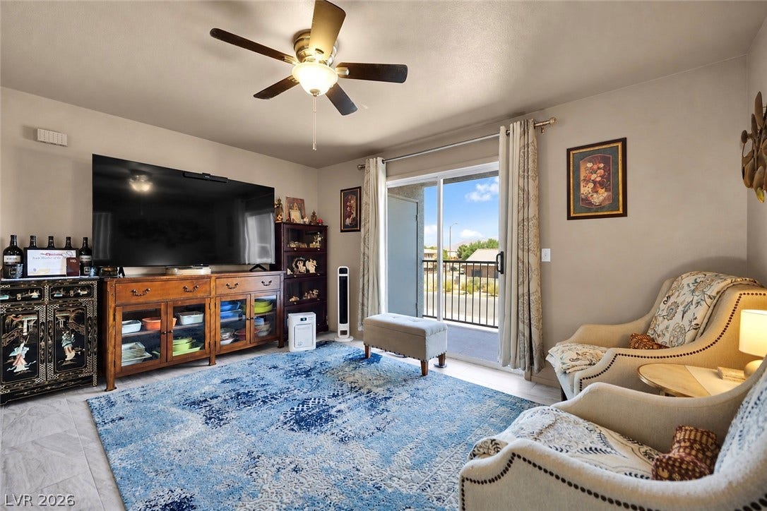 1520 Frank Aved Street, #201, Las Vegas, NV 89110 Sliding glass doors open to a private balcony, filling the space with natural light.