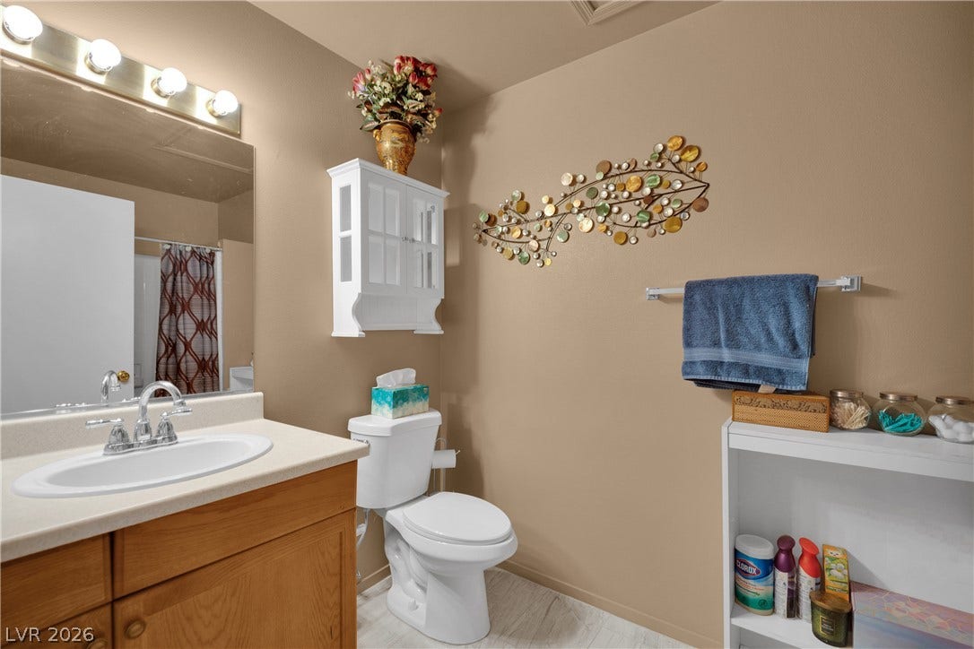 1520 Frank Aved Street, #201, Las Vegas, NV 89110 A functional vanity setup and neat storage cabinets define this well-appointed bathroom space.