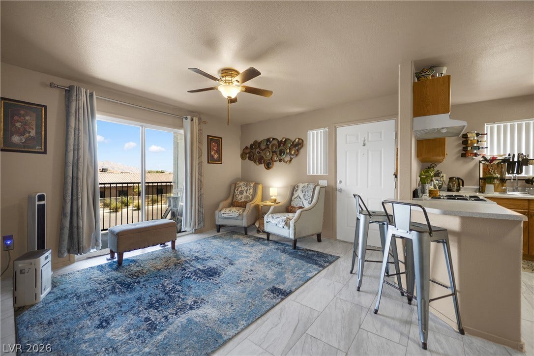 1520 Frank Aved Street, #201, Las Vegas, NV 89110 An open layout connects the living area to a casual breakfast bar over tiled flooring.