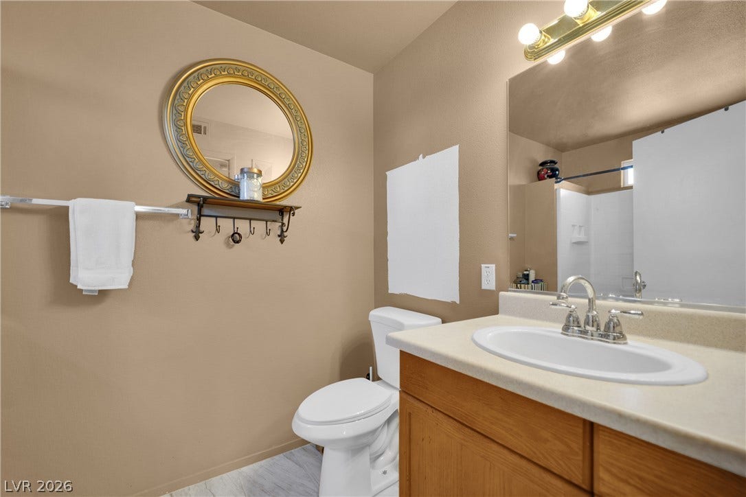 1520 Frank Aved Street, #201, Las Vegas, NV 89110 Functional layout highlights a warm-toned vanity area complete with a large mirror.