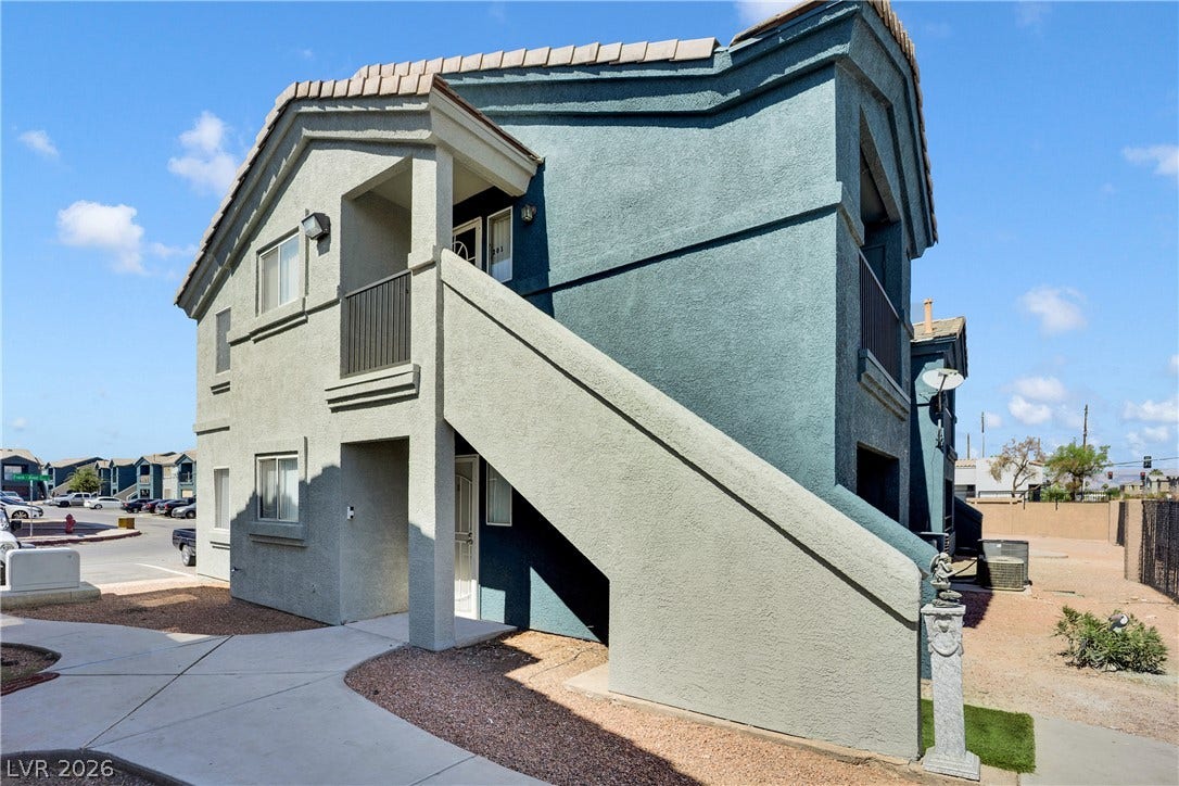 1520 Frank Aved Street, #201, Las Vegas, NV 89110 An external staircase leads to private entryways in this multi-level stucco building.