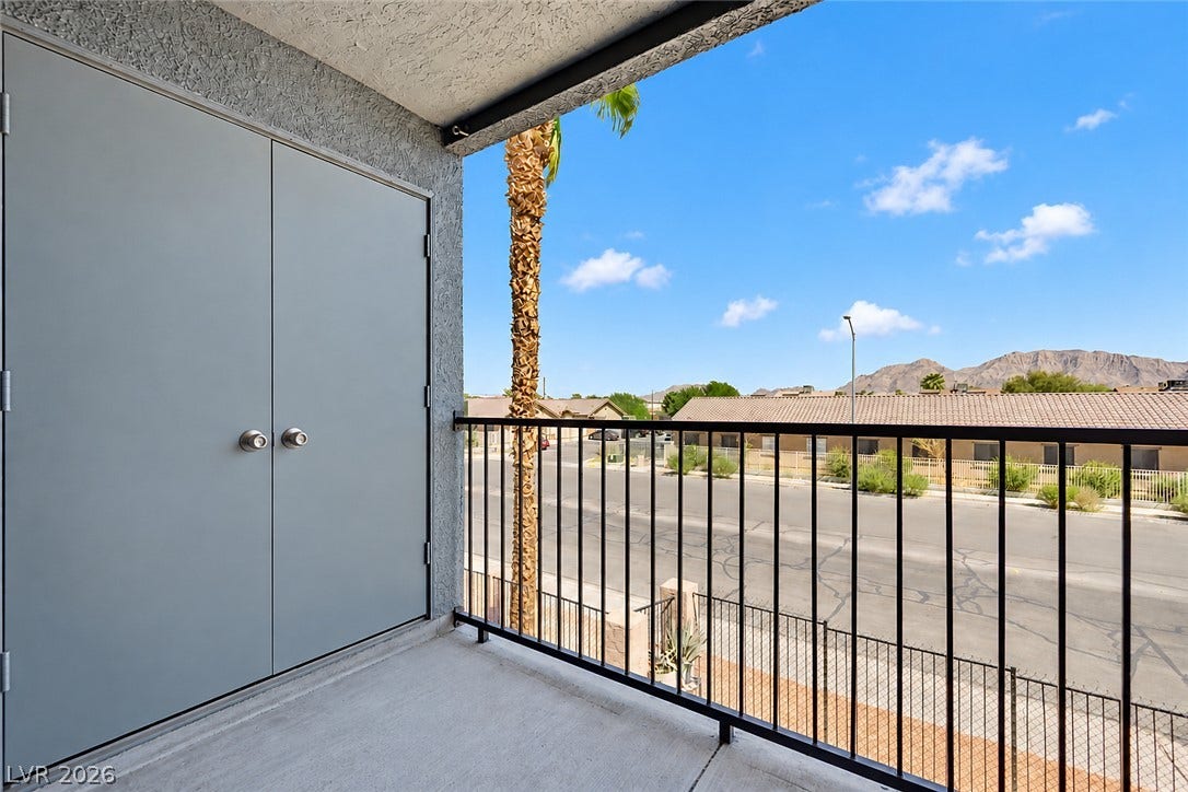 1520 Frank Aved Street, #201, Las Vegas, NV 89110 Mountain views elevate this concrete balcony featuring integrated storage and classic metal railings.