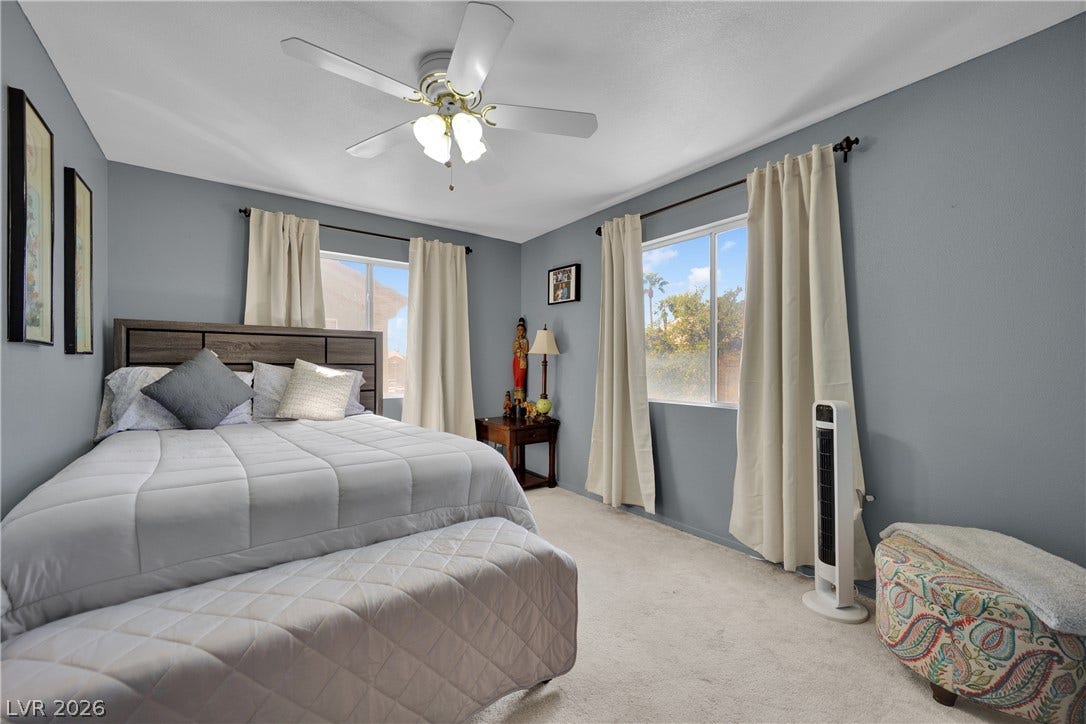 1520 Frank Aved Street, #201, Las Vegas, NV 89110 Sunlight streams through multiple windows onto the soft wall-to-wall carpeting of this bedroom.