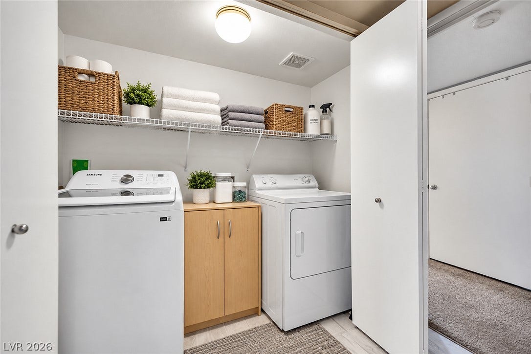 1520 Frank Aved Street, #201, Las Vegas, NV 89110 Functional layout maximizes utility with overhead shelving and dedicated spaces for laundry appliances.
