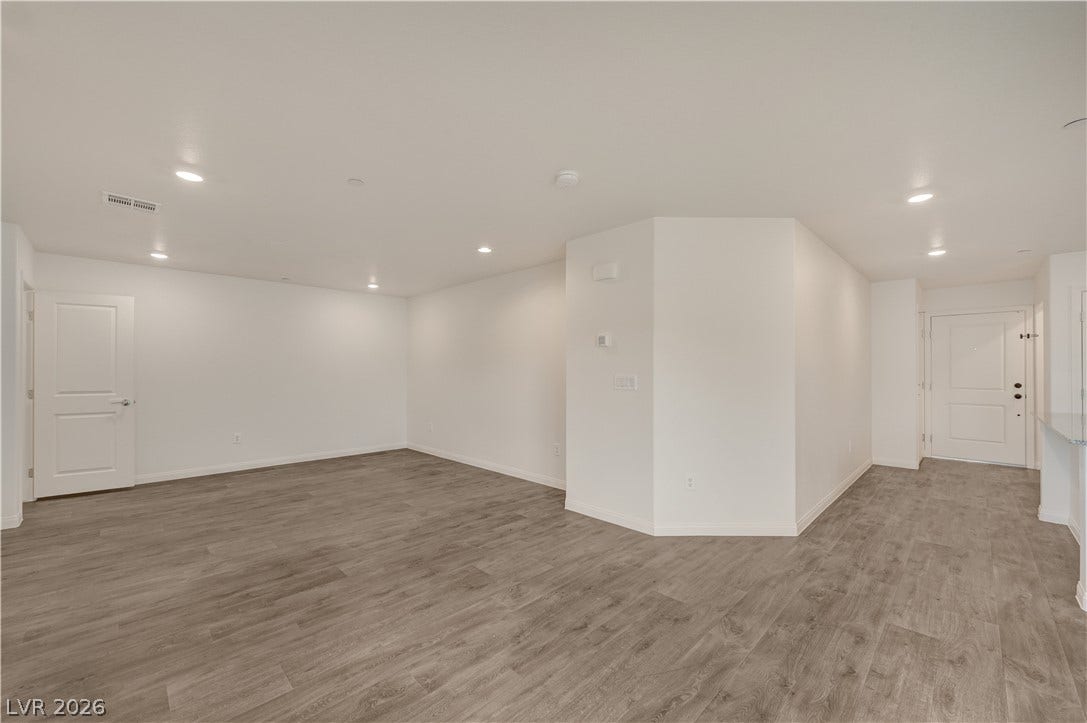 Clean lines and durable plank flooring define this versatile, open living area.