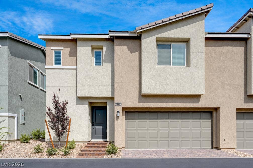 A modern multi-level exterior displays clean architectural lines under a clear sky.