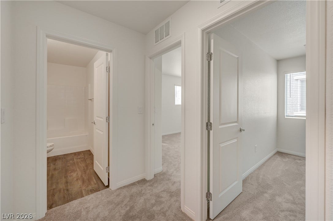 Carpeted hallways connect multiple private rooms in a highly functional layout.
