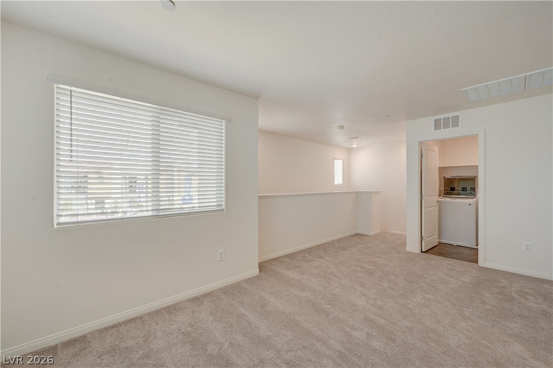 A versatile upper-level loft features wall-to-wall carpeting and access to a convenient laundry closet.