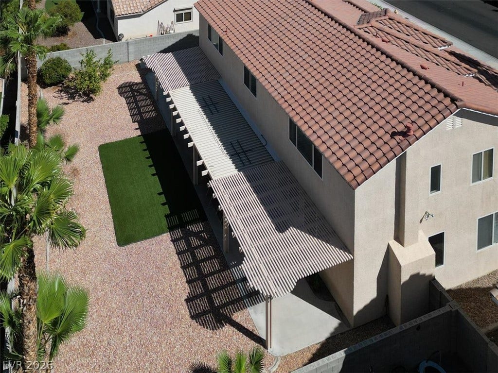 6329 Snow Cactus Street, North Las Vegas, NV 89031 An aerial perspective showcases the extensive backyard patio cover and classic tile roof.