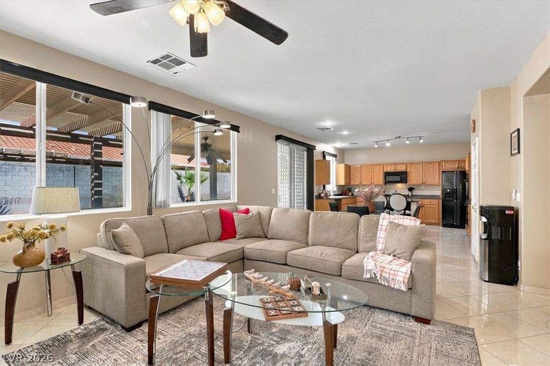 6329 Snow Cactus Street, North Las Vegas, NV 89031 Polished tile flooring flows seamlessly through this open-concept design.