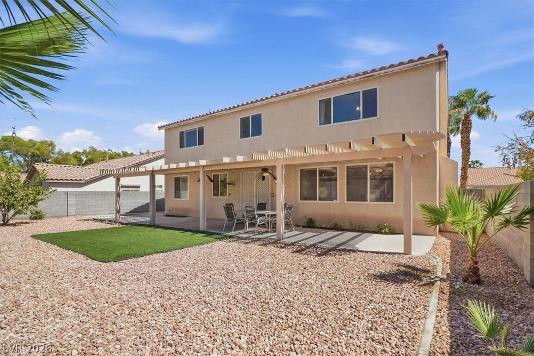 6329 Snow Cactus Street, North Las Vegas, NV 89031 An inviting backyard patio sits beneath a classic pergola structure overlooking the low-maintenance gravel yard.