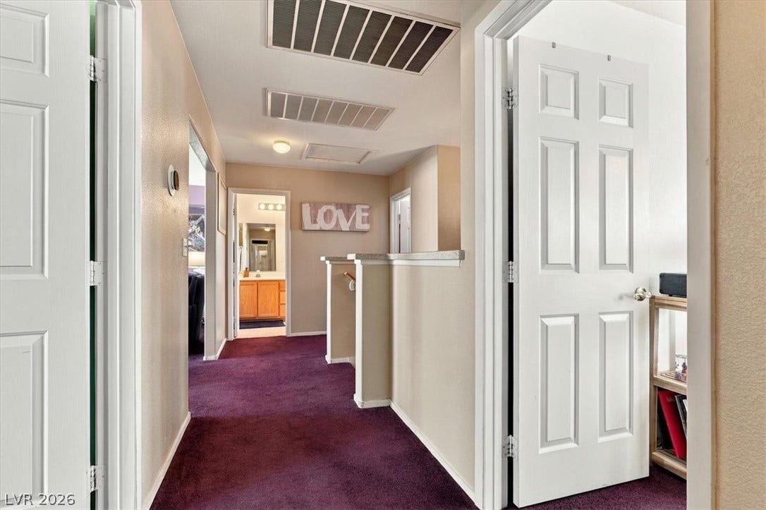 6329 Snow Cactus Street, North Las Vegas, NV 89031 A spacious upper-level landing connects the home with classic white doors and soft carpeting.