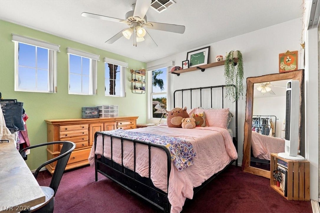 6329 Snow Cactus Street, North Las Vegas, NV 89031 Natural light streams through multiple windows to illuminate this cozy bedroom with wall-to-wall carpeting.