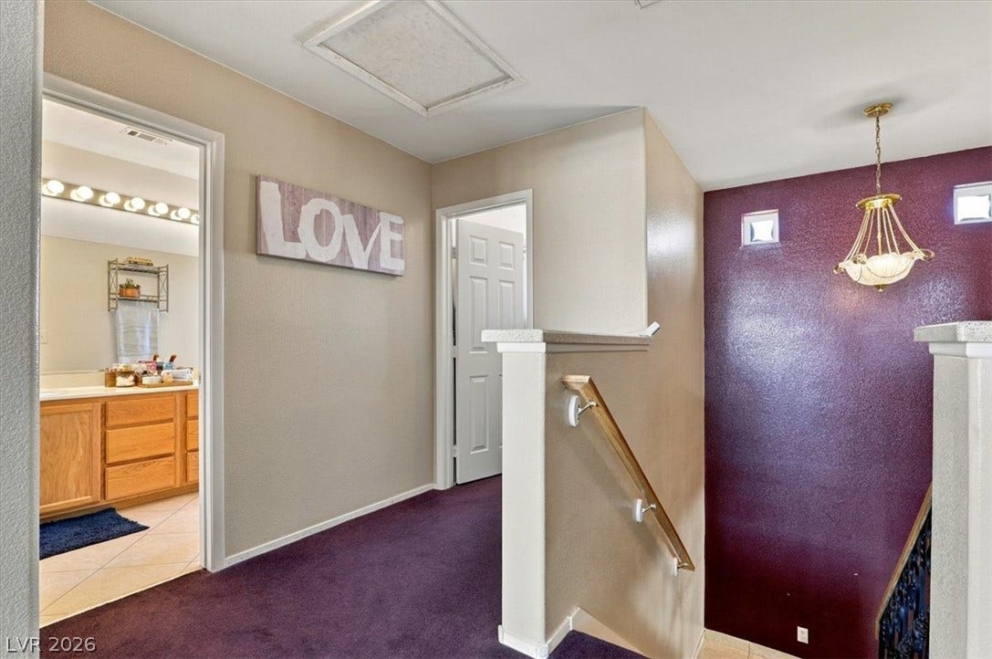 6329 Snow Cactus Street, North Las Vegas, NV 89031 A spacious upper landing connects the bedrooms and bathrooms with carpeted flooring and natural light.