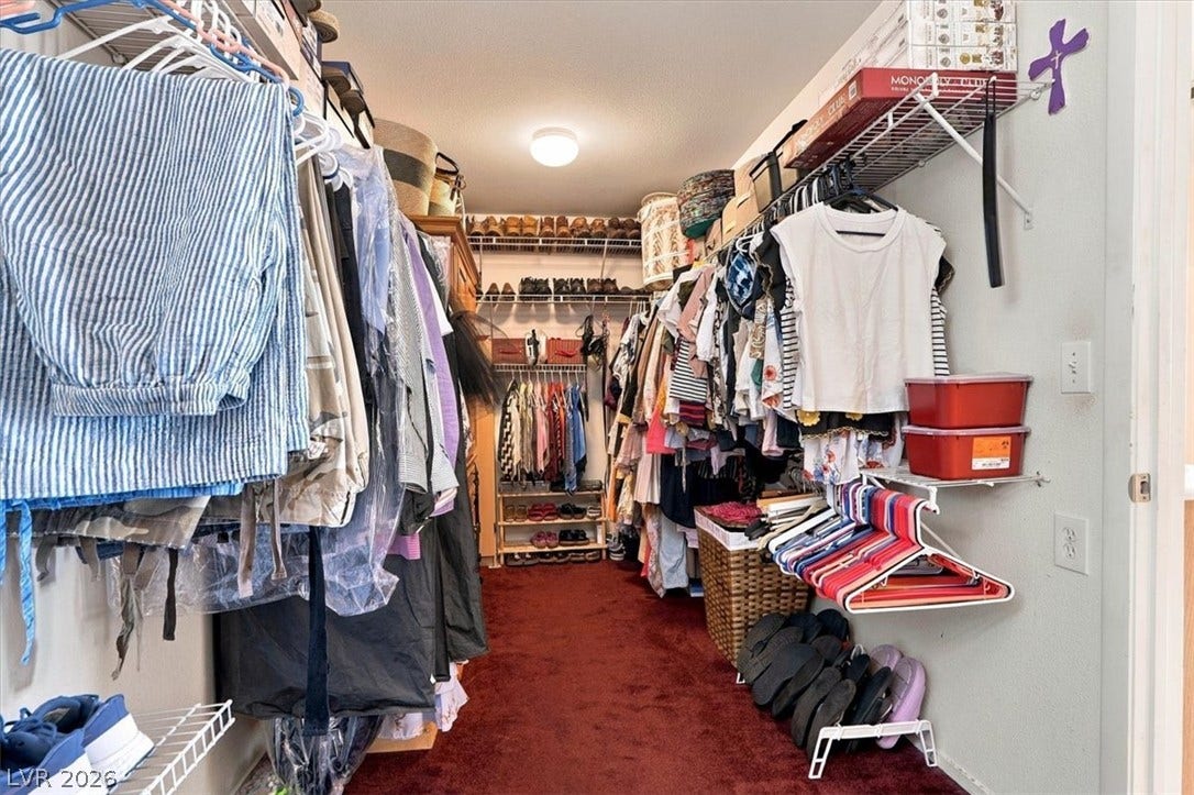 6329 Snow Cactus Street, North Las Vegas, NV 89031 Ample hanging rods and integrated shelving optimize storage capacity in this deep walk-in closet.