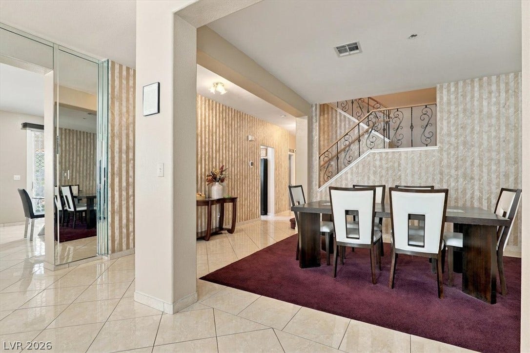 6329 Snow Cactus Street, North Las Vegas, NV 89031 Polished tile flooring flows seamlessly from the open entry hall into the formal dining room.