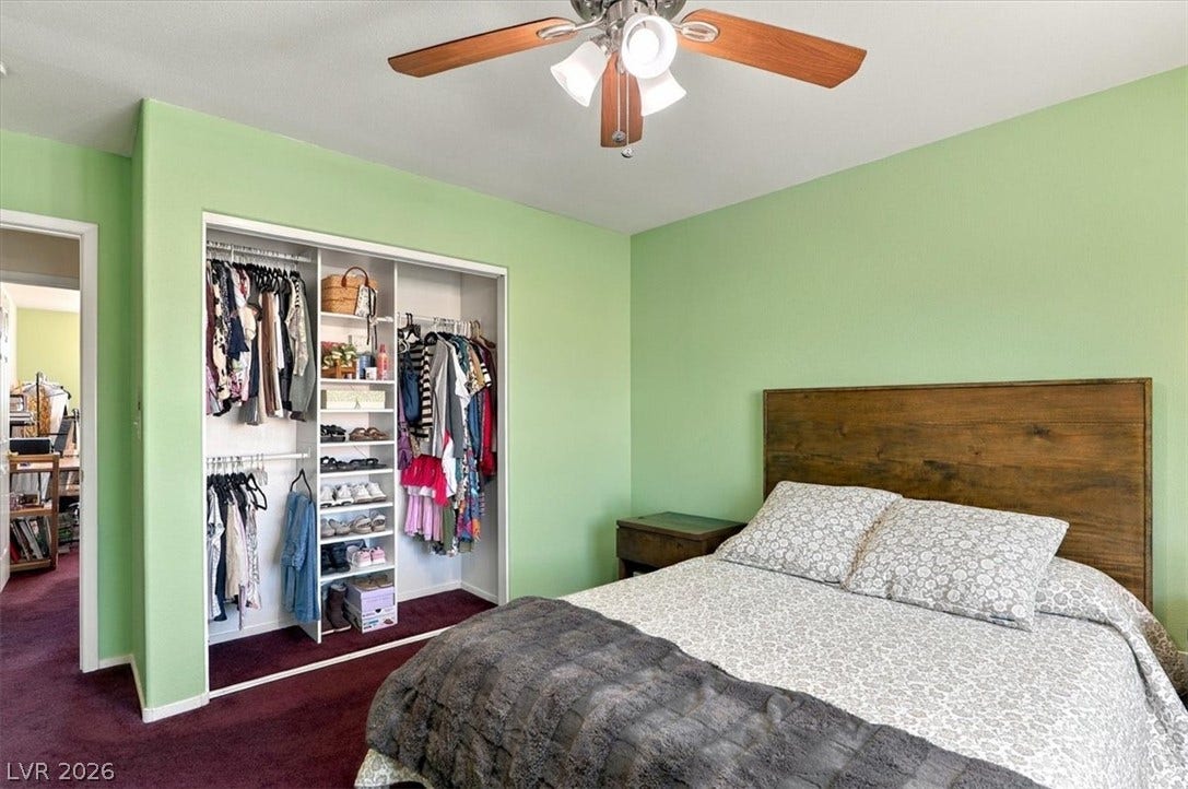 6329 Snow Cactus Street, North Las Vegas, NV 89031 Richly carpeted floors anchor this comfortable bedroom featuring a built-in closet storage system.