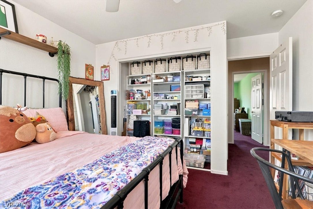 6329 Snow Cactus Street, North Las Vegas, NV 89031 Richly carpeted floors anchor this comfortable bedroom featuring a built-in closet storage system.