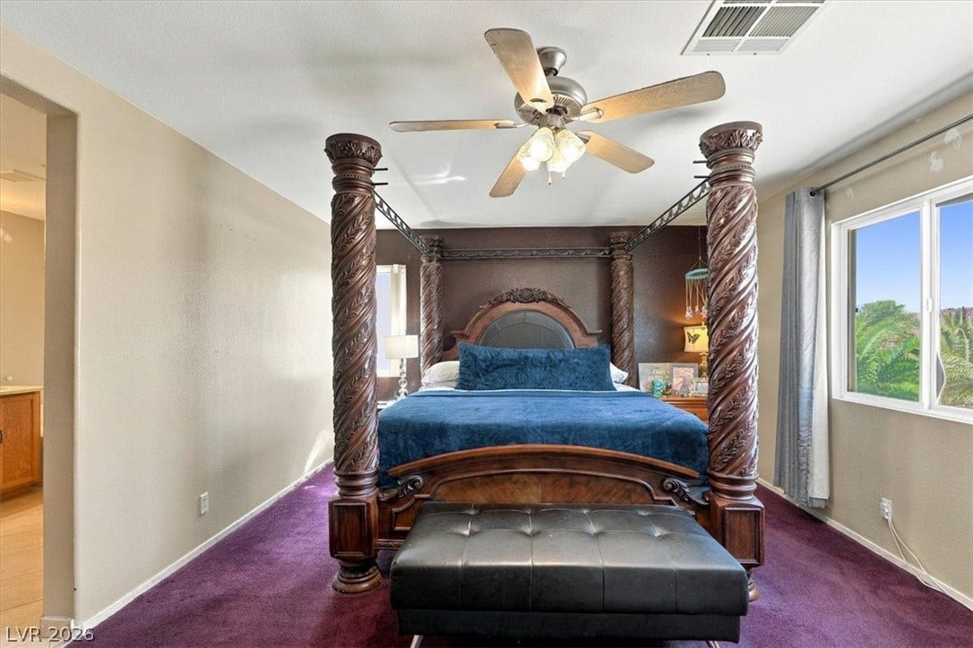 6329 Snow Cactus Street, North Las Vegas, NV 89031 A spacious bedroom features plush carpet and wide windows overlooking the neighborhood greenspace.