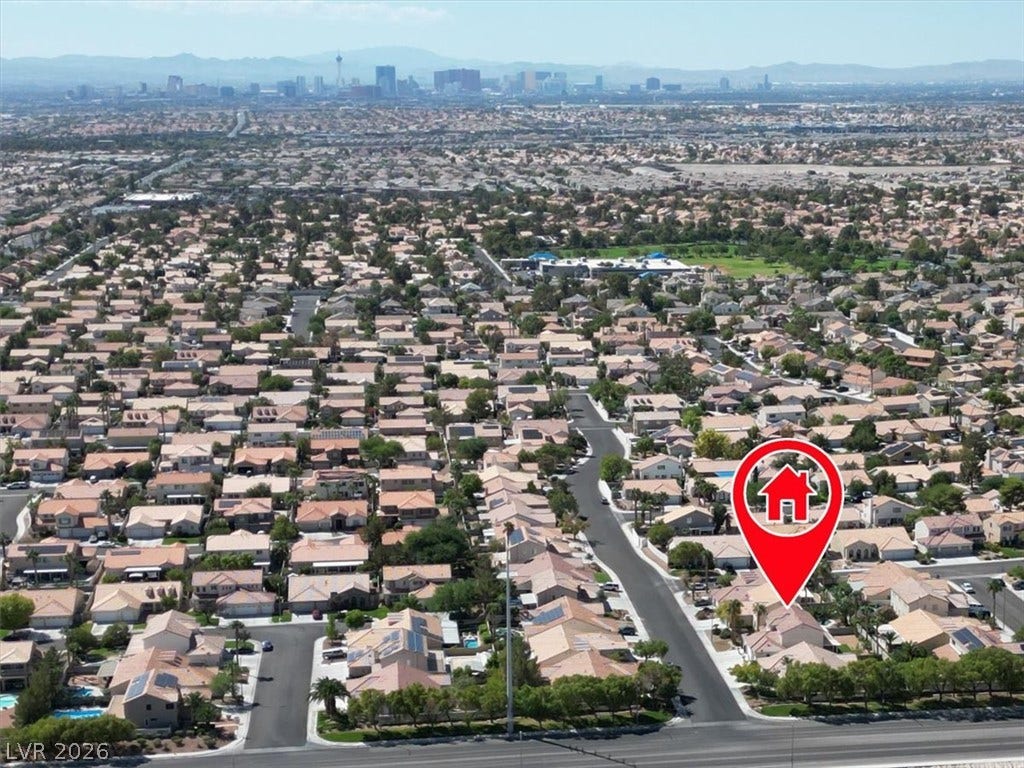 6329 Snow Cactus Street, North Las Vegas, NV 89031 An aerial perspective reveals the residential neighborhood surrounding this home, with distant mountain views.