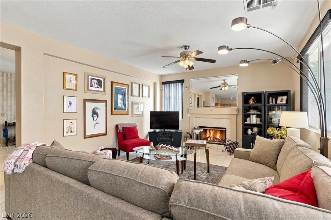 6329 Snow Cactus Street, North Las Vegas, NV 89031 An inviting fireplace serves as the focal point of this warm living space.