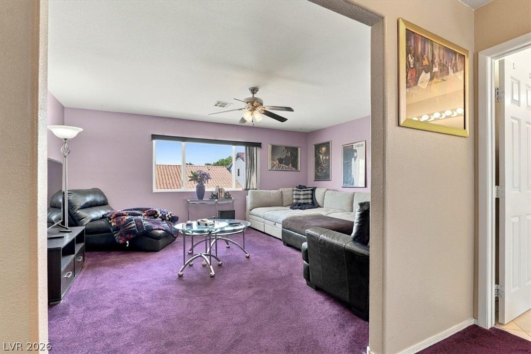 6329 Snow Cactus Street, North Las Vegas, NV 89031 A spacious living area features soft carpeting and views of the surrounding neighborhood.