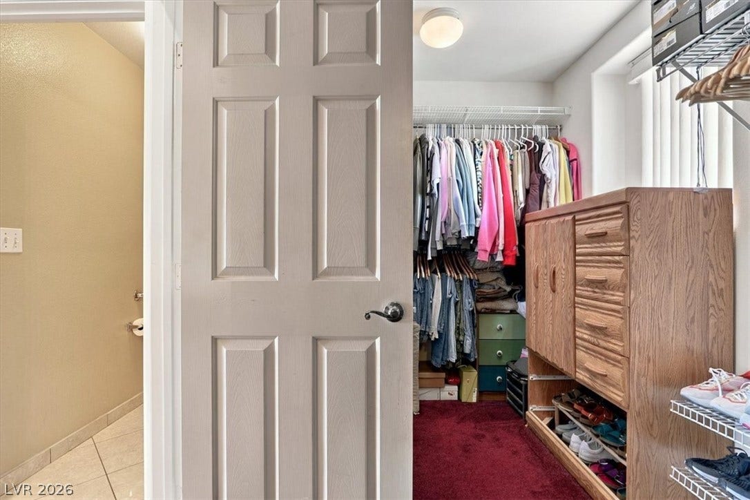 6329 Snow Cactus Street, North Las Vegas, NV 89031 Ample closet space with integrated shelving sits adjacent to the tiled bathroom.