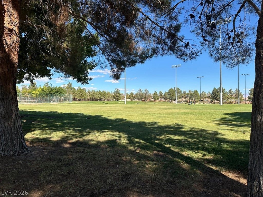 6329 Snow Cactus Street, North Las Vegas, NV 89031 Mature trees frame a view across the expansive green lawns of a nearby community park.