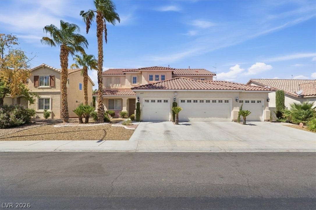 6329 Snow Cactus Street, North Las Vegas, NV 89031 Palm trees frame the classic tile roof and spacious multi-car garage of this multi-level home.