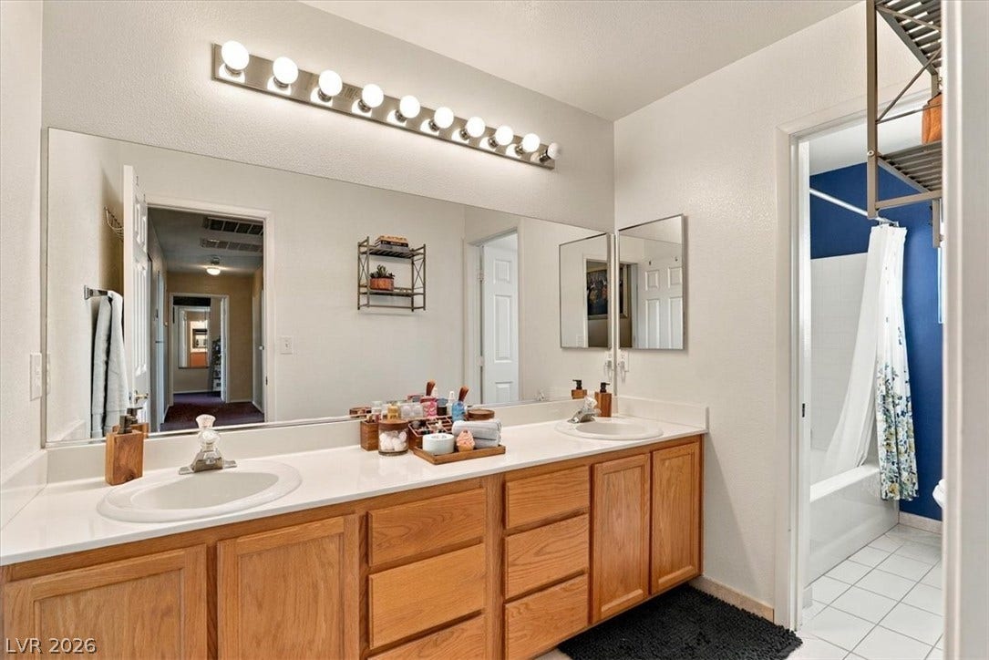 6329 Snow Cactus Street, North Las Vegas, NV 89031 A spacious double vanity anchors this master bathroom, leading into a separate tub area.