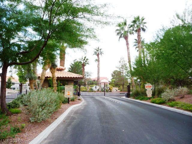 A secure gated entrance leads into this beautifully landscaped community lined with palm trees.
