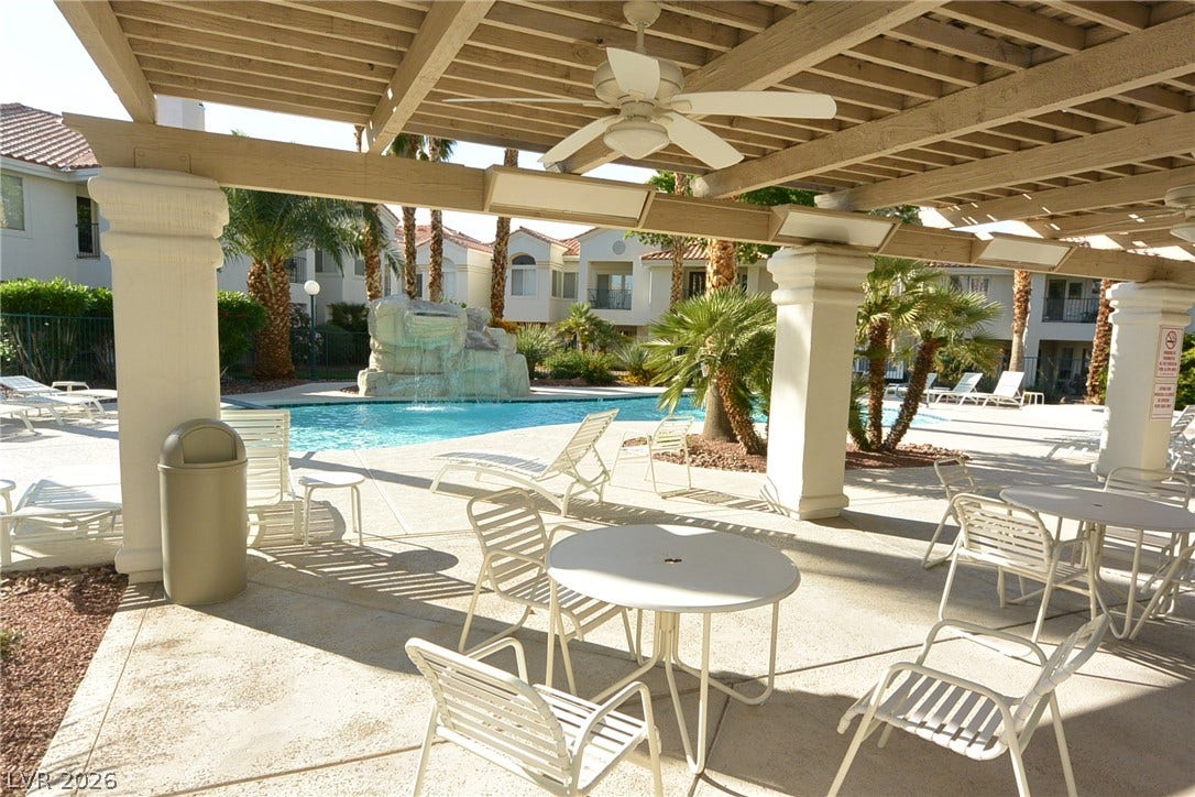 Shaded seating areas offer views over the resort-style community pool and waterfall feature.