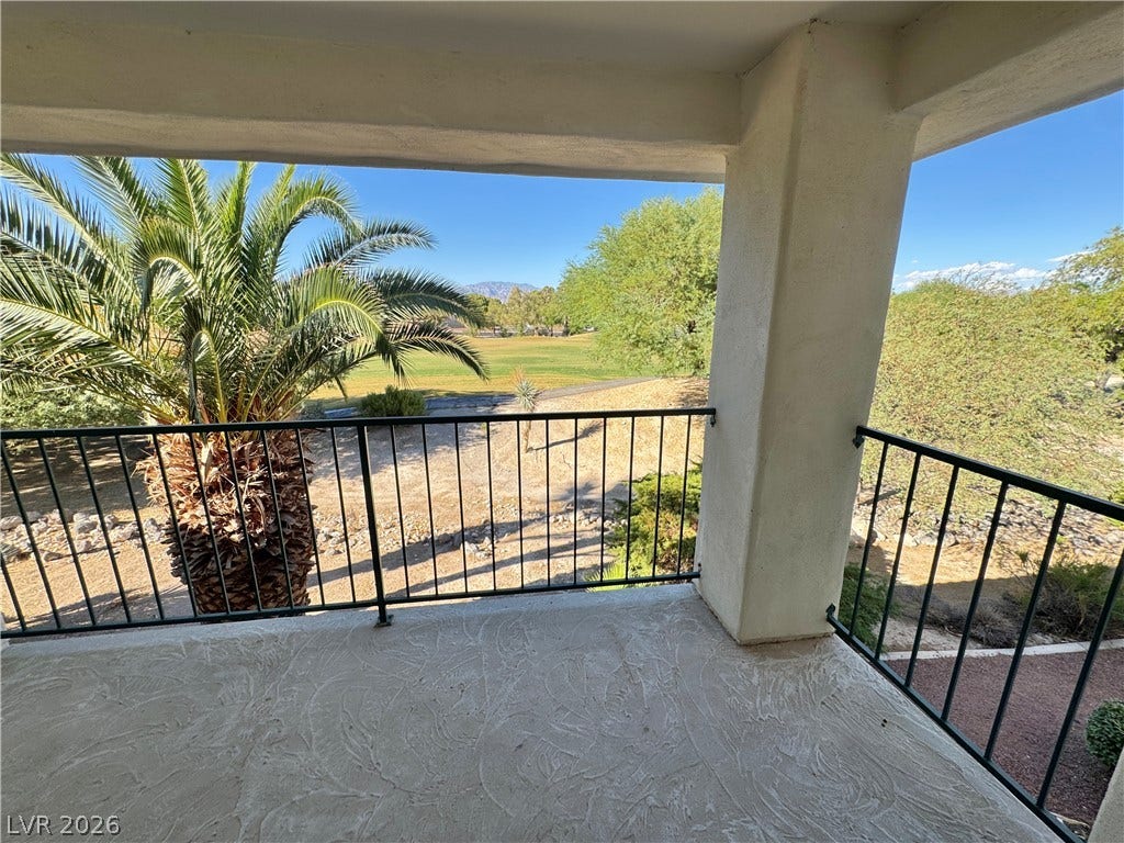 Mountain and golf course views frame this covered balcony.