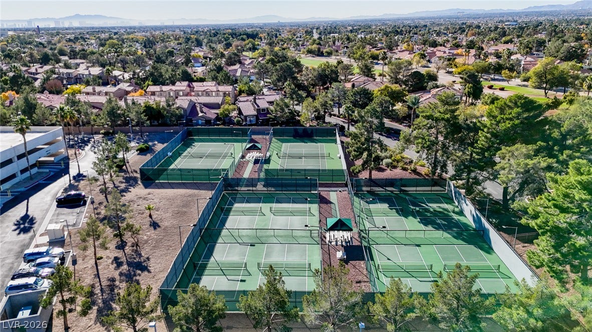 Multiple tennis courts sit surrounded by mature trees in this neighborhood community facility.