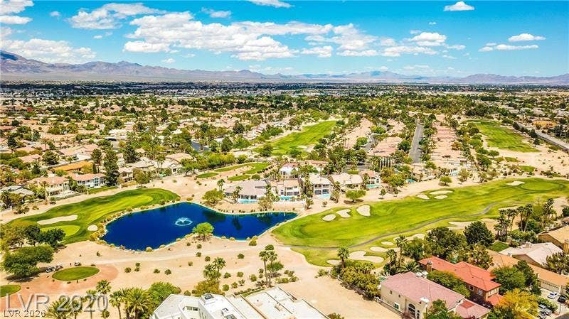 A sweeping panorama captures this pristine desert community flanked by a lush green fairway.
