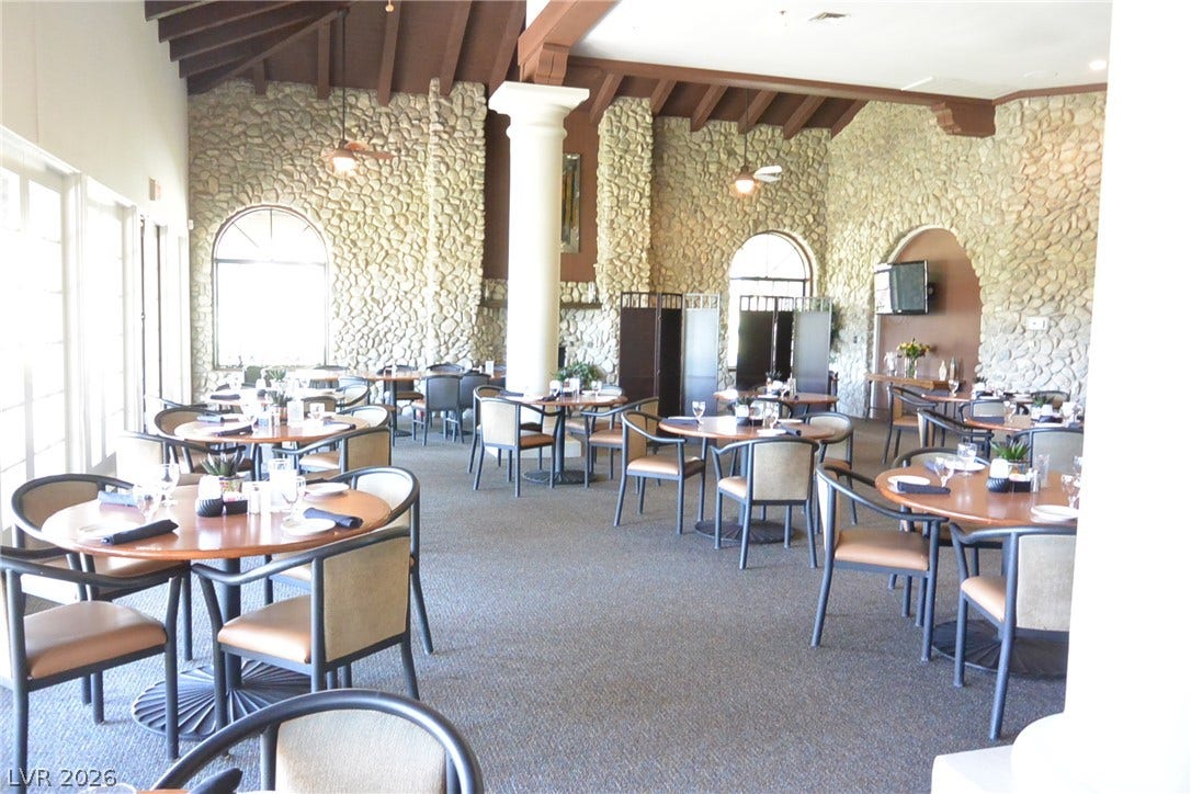 Stone walls and exposed timber beams bring rich character to this spacious dining hall.