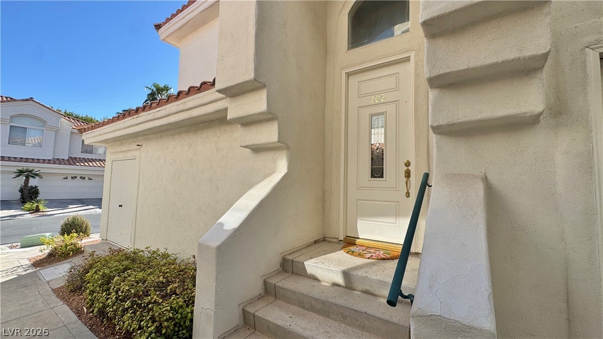 Concrete steps lead up to a private entrance.