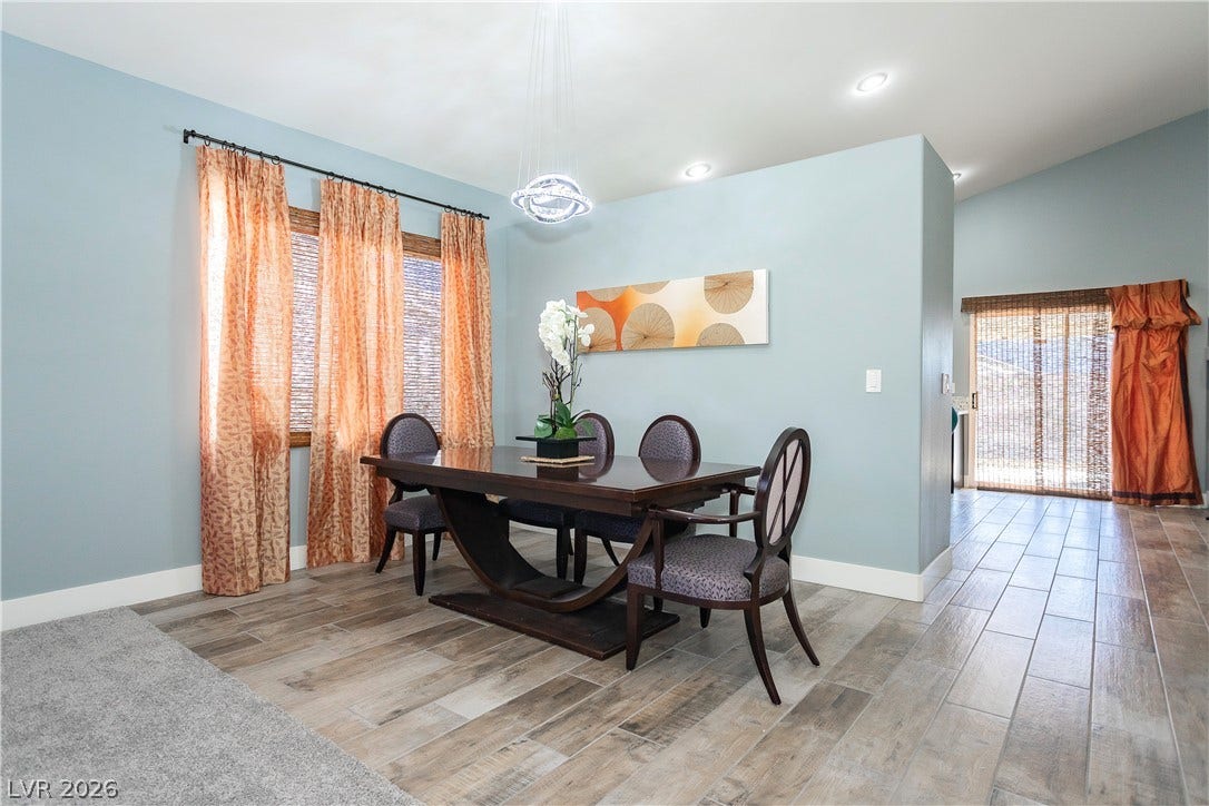 2421 Sunrise Springs Court, North Las Vegas, NV 89031 Plank flooring and an open flow design define this elegant mealtime setting.