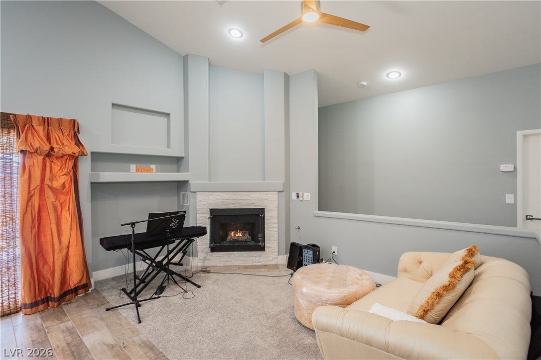 2421 Sunrise Springs Court, North Las Vegas, NV 89031 A corner fireplace and recessed wall niches highlight this comfortable living space.