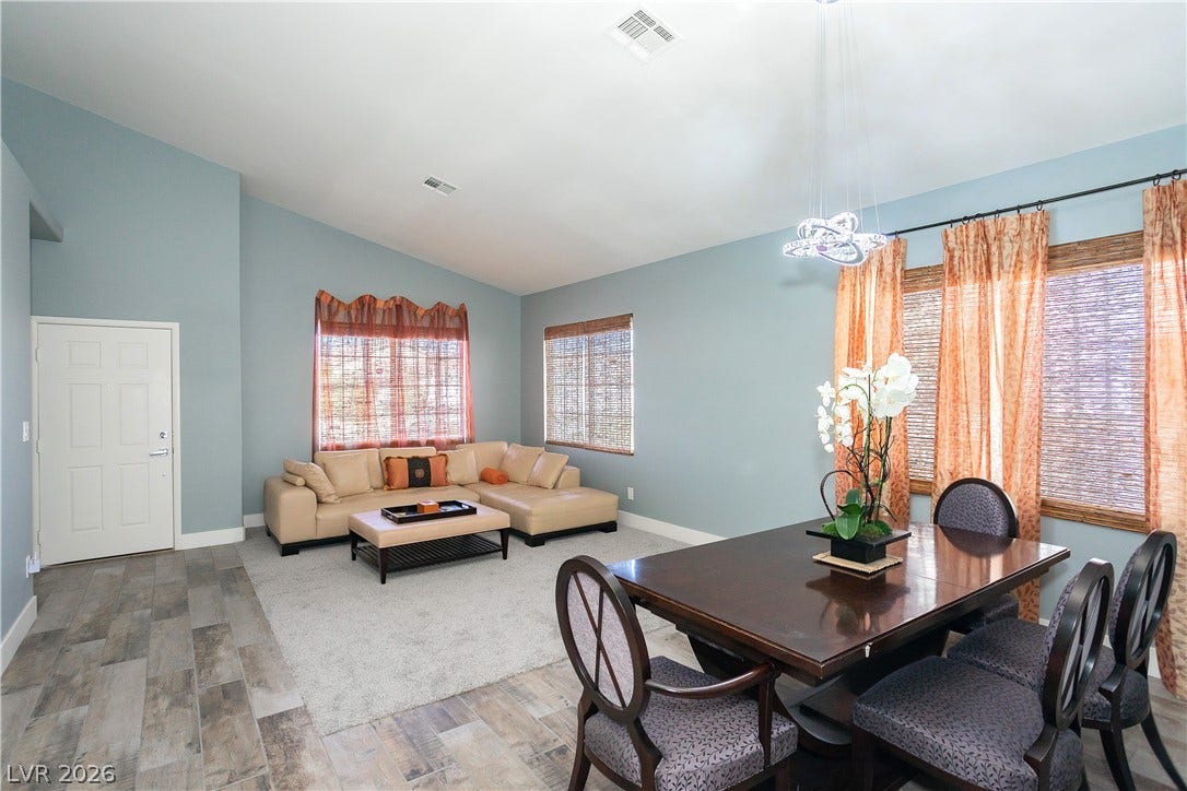 2421 Sunrise Springs Court, North Las Vegas, NV 89031 Vaulted ceilings soar over this versatile open-concept living and dining space with tile flooring.