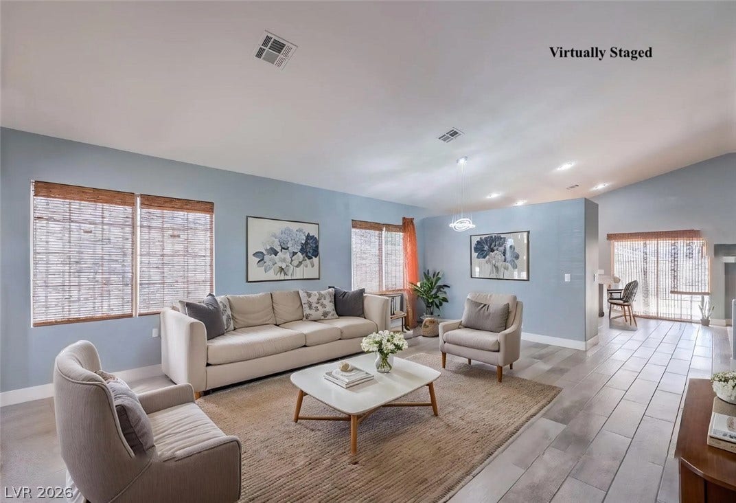 2421 Sunrise Springs Court, North Las Vegas, NV 89031 Gleaming wood-look tile floors complement the airy vaulted ceilings in this open living area.