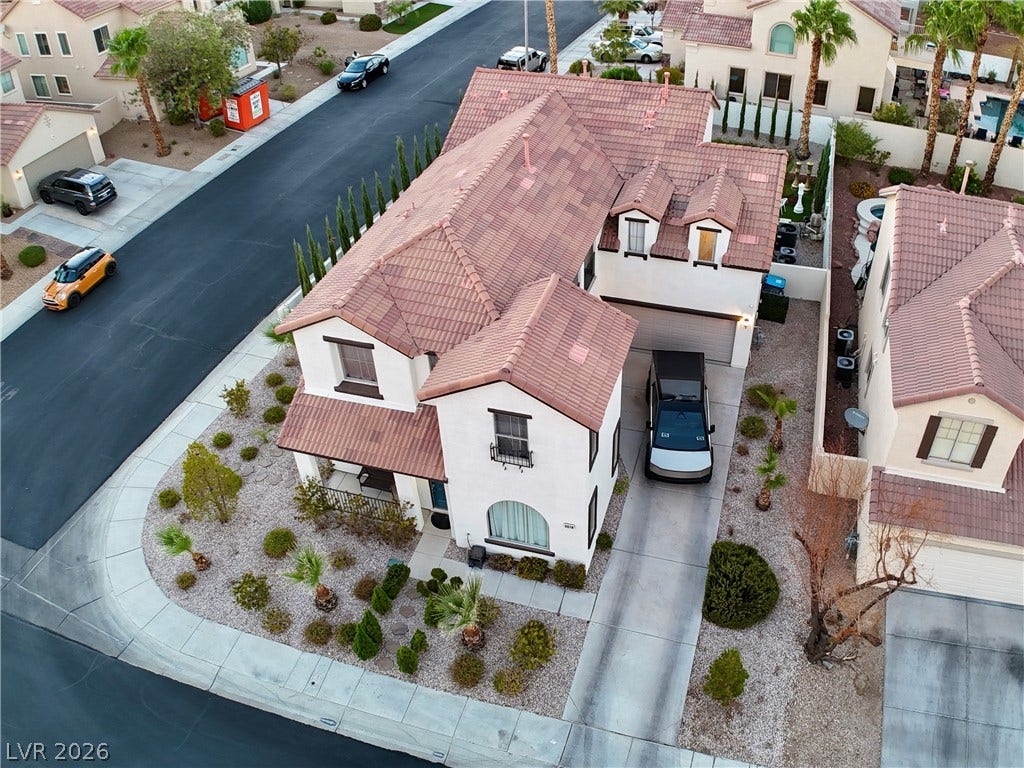 3018 Via Sarafina Drive, Henderson, NV 89052 An aerial perspective showcases the multi-level tiled roofline and desert landscaping on a corner lot.
