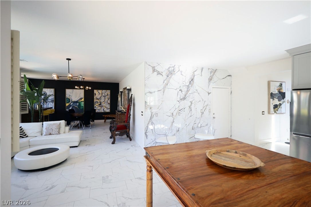 3018 Via Sarafina Drive, Henderson, NV 89052 Gleaming stone tile floors unite the open layout with clean lines and striking marble accents.