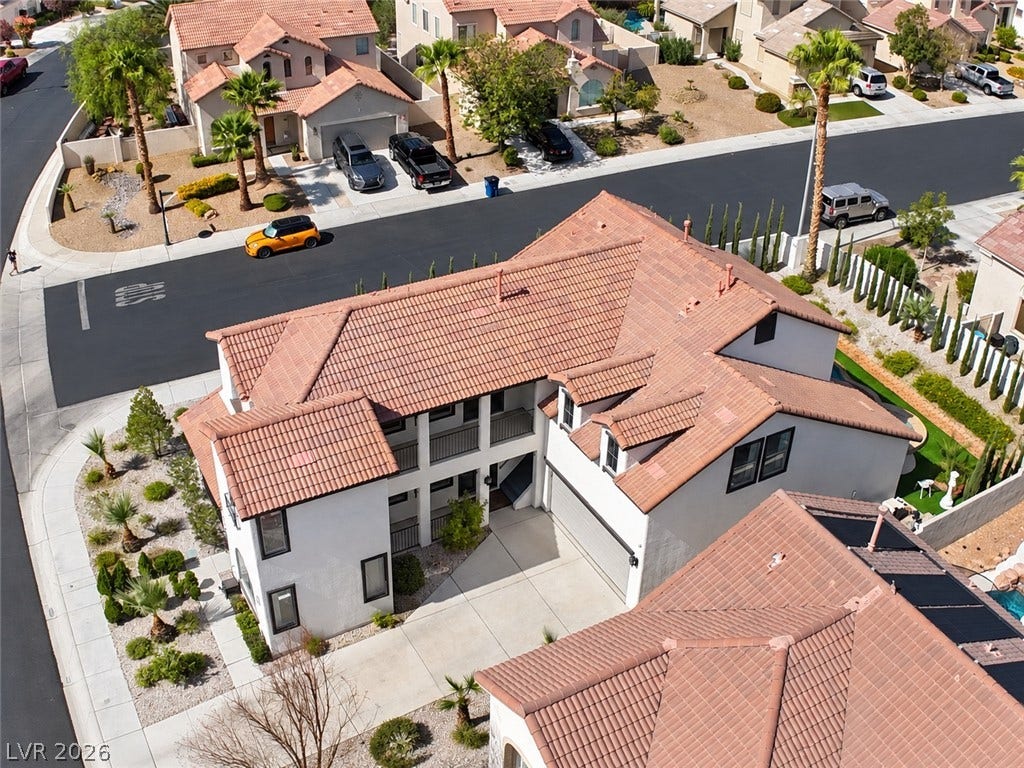 3018 Via Sarafina Drive, Henderson, NV 89052 An aerial perspective showcases the distinctive tile roof and stucco exterior of this multi-level home.