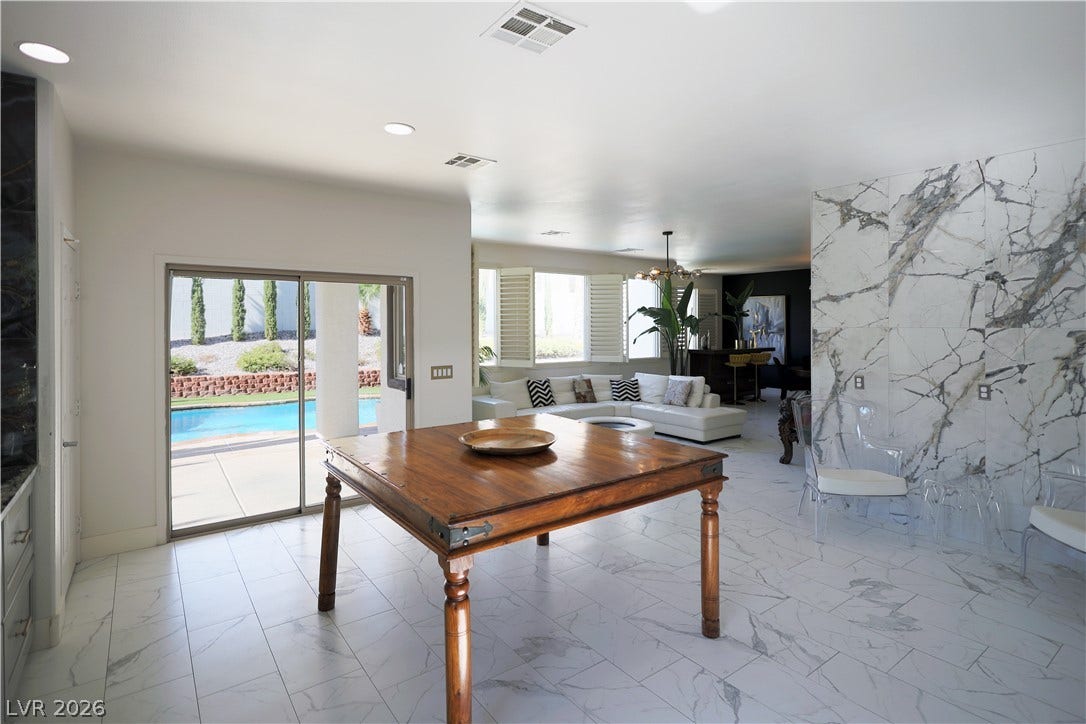 3018 Via Sarafina Drive, Henderson, NV 89052 Gleaming marble tile floors pair with glass sliding doors opening directly to the pool.